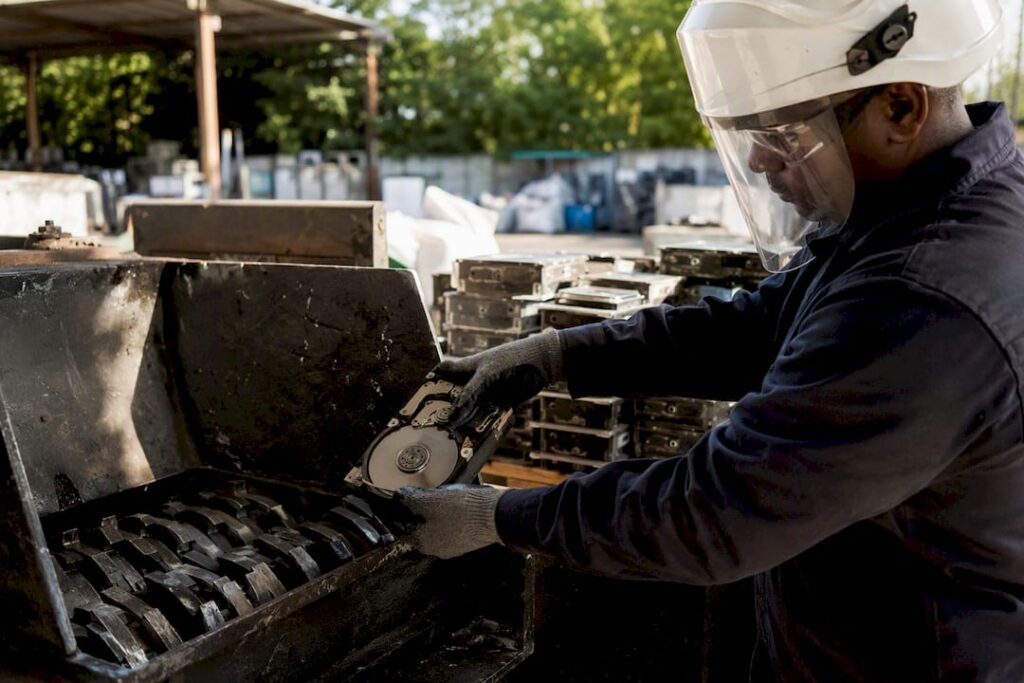 Technician physically shredding hard drive