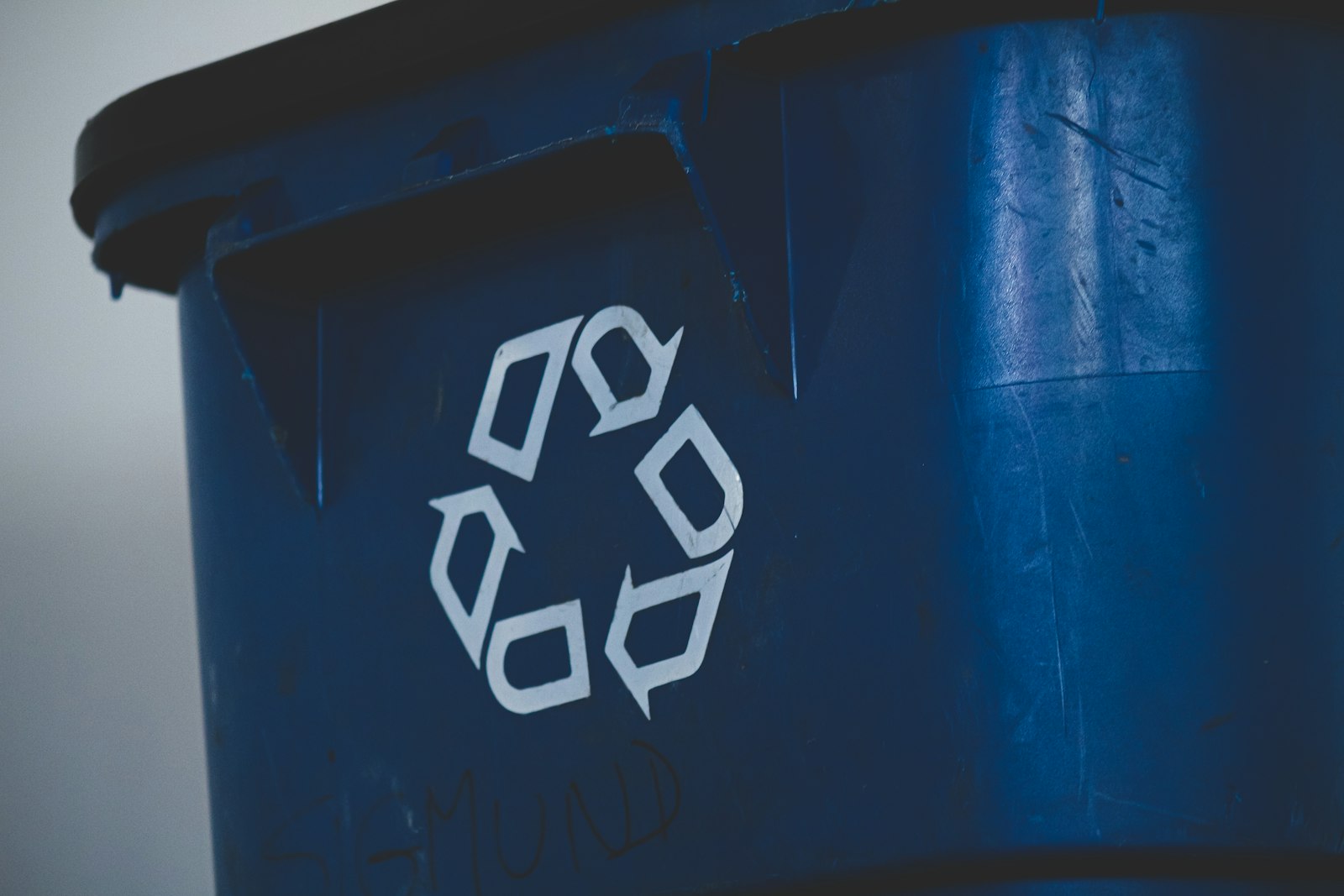 Blue recycling bin with recycling symbol